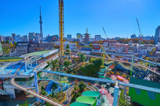 Asakusa Hanayashiki rides with Tokyo Skytree and pagoda in the background